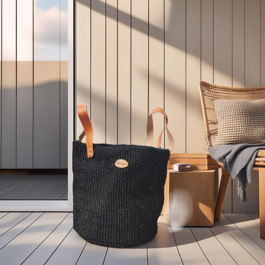 Handwoven boho black  basket with leather handles in Nordic living room decor