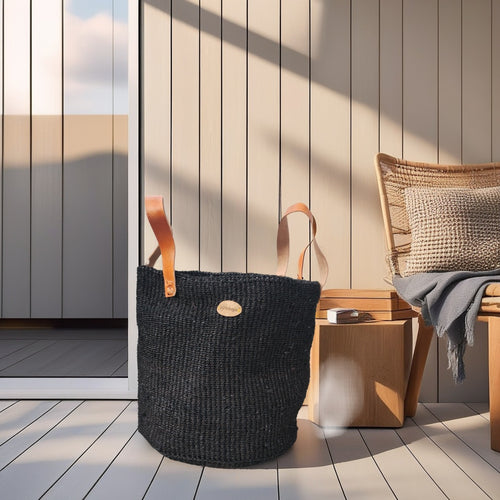 Handwoven boho black  basket with leather handles in Nordic living room decor
