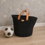 Handmade black sisal basket with leather handles for toy storage and home décor in a Scandinavian-style room_Nokupa